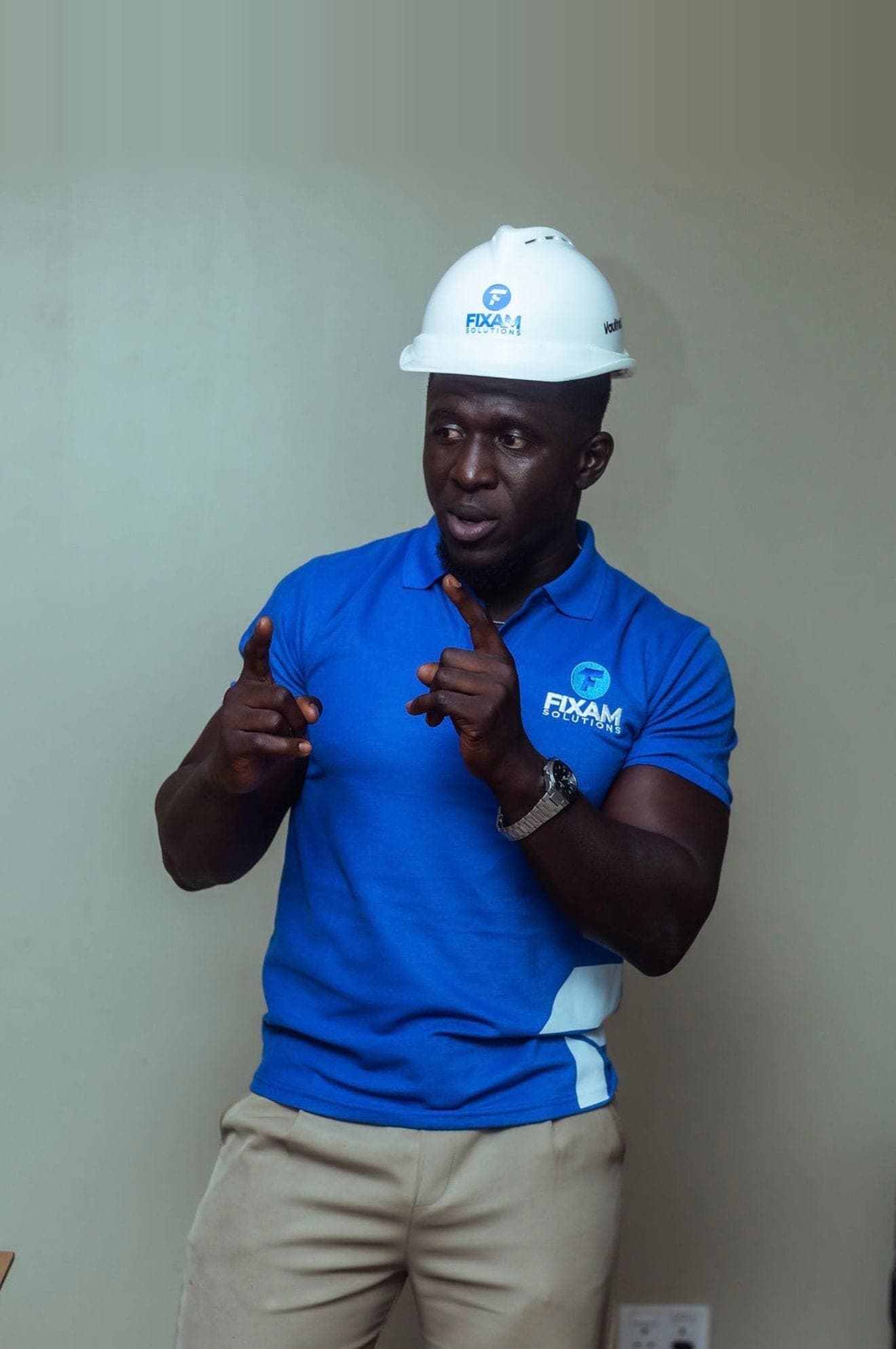 A FixAm technician in a branded hard hat and polo shirt